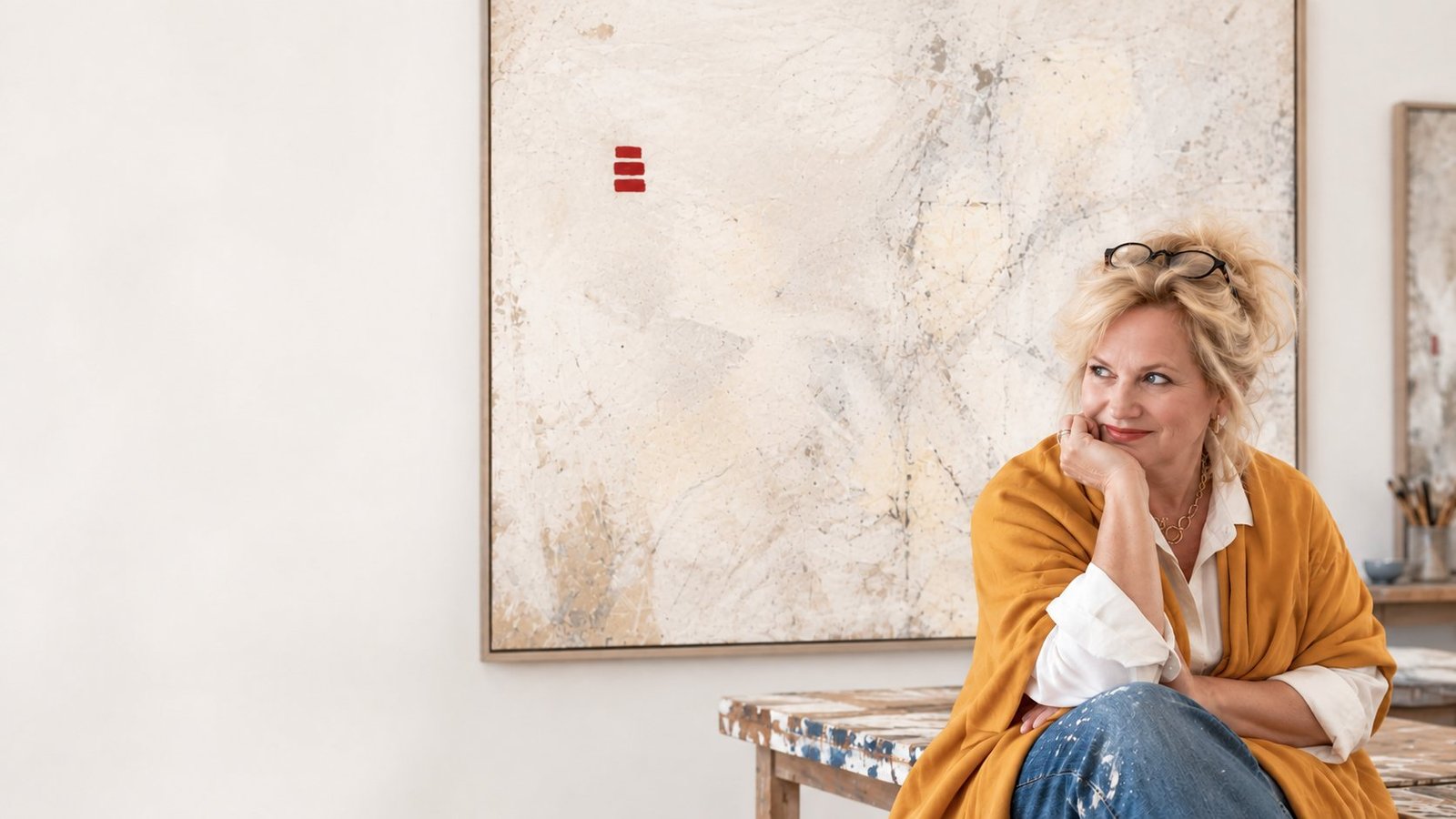 Christine Patterson in her studio with a painting from Walls of Time